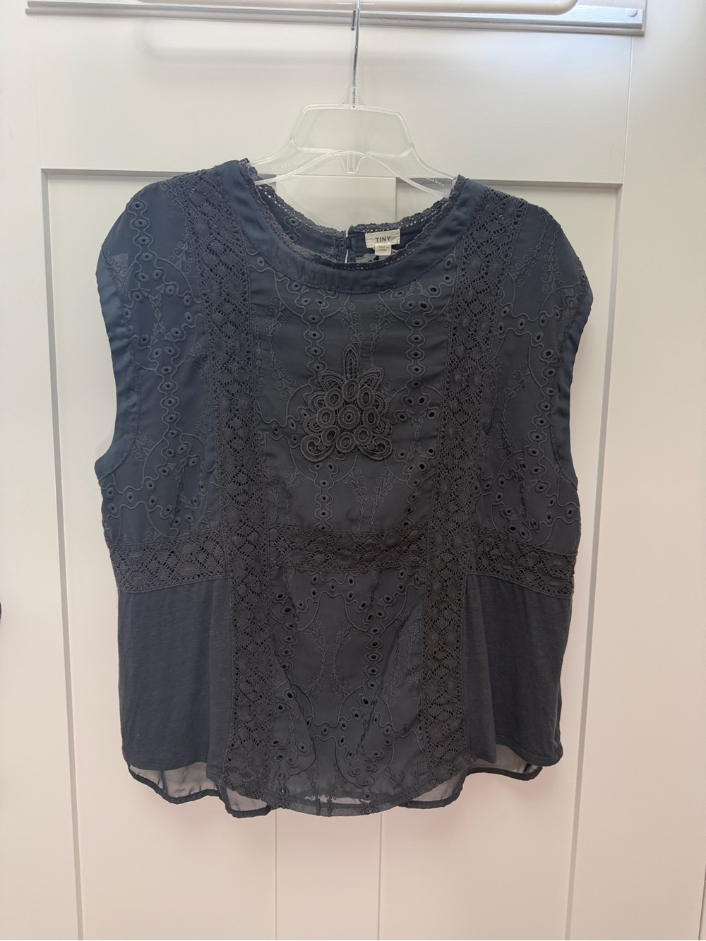 Fun & elegant sleeveless top with eyelet overlay